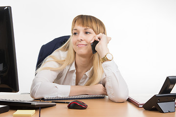 Image showing Business woman happy talking on cell phone and looking at the monitor screen