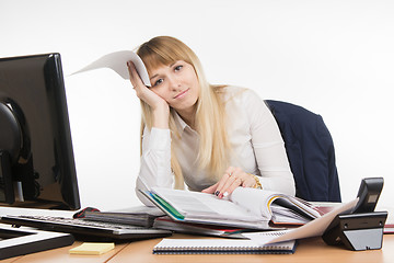 Image showing The sad girl in the office delves into securities