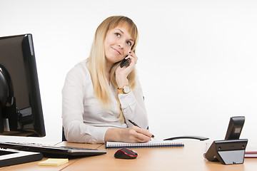 Image showing Happy business woman flirts talking on a mobile phone