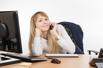 Image showing Happy business woman talking on a cell phone in the office