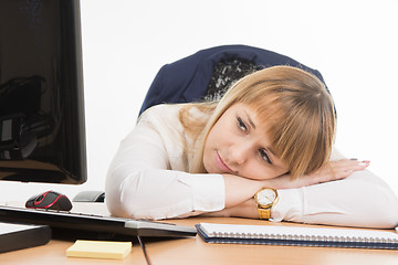 Image showing Office a specialist wearily lay down on the table and looked at the screen