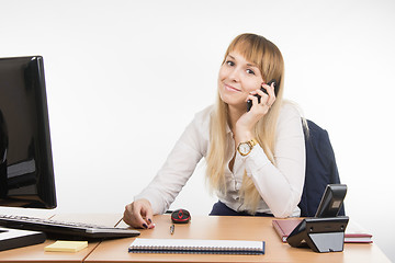 Image showing Office Specialist talking on a cell phone in the workplace