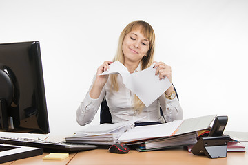 Image showing Business girl having fun tearing the paper document