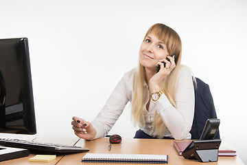 Image showing Office Specialist talking on a cell phone in the workplace