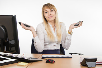 Image showing Secretary holding two phone rang - and mobile working