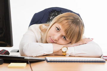 Image showing Office a specialist wearily lay down on the table and looked at the frame