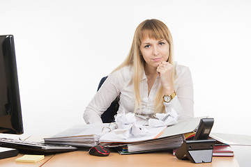 Image showing Office Specialist nervously squeezed a few papers and evil looks in the frame