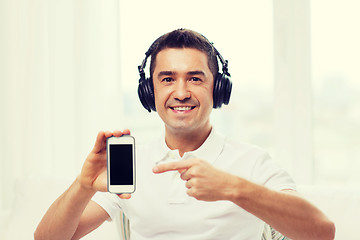 Image showing happy man with smartphone and headphones