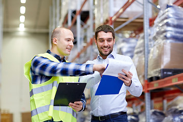 Image showing worker and businessmen with clipboard at warehouse