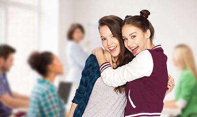 Image showing happy teenage student girls hugging at school