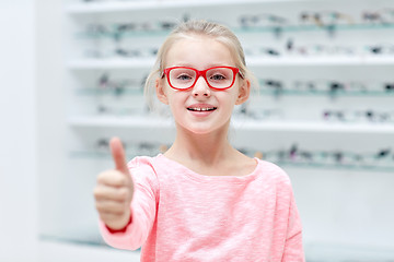 Image showing girl in glasses at optics store showing thumbs up