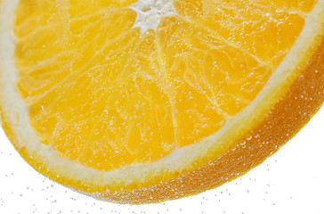 Image showing orange slice falling or dipping in water 