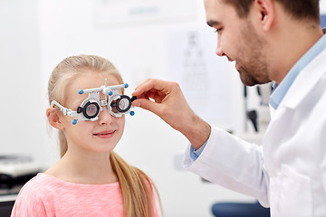 Image showing optician with trial frame and girl at clinic