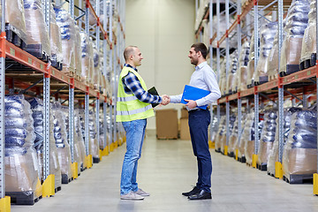 Image showing worker and businessmen with clipboard at warehouse