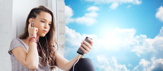 Image showing teenage girl with smartphone and earphones