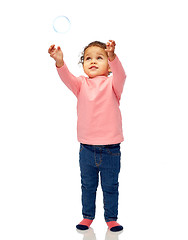 Image showing little baby girl playing with soap bubble