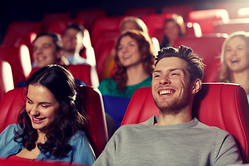 Image showing happy friends watching movie in theater