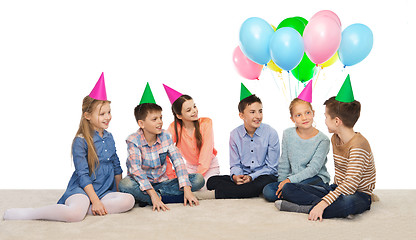 Image showing happy smiling children in party hats on birthday