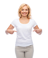 Image showing smiling woman in white t-shirt pointing to herself