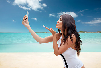 Image showing young woman taking selfie with smartphone