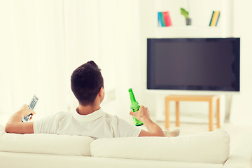 Image showing man watching tv and drinking beer at home