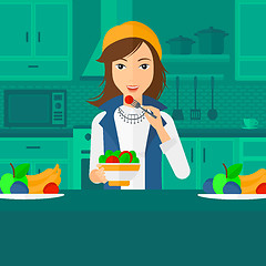 Image showing Woman eating salad.