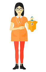 Image showing Pregnant woman with clothes for baby.