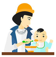 Image showing Woman feeding baby.