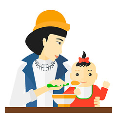 Image showing Woman feeding baby.