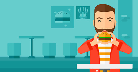 Image showing Man eating hamburger. 