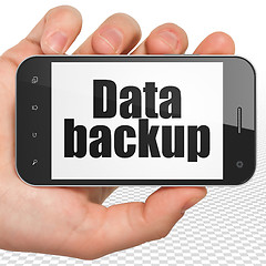 Image showing Information concept: Hand Holding Smartphone with Data Backup on display
