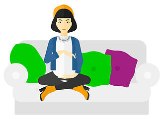 Image showing Pregnant woman sitting on sofa.