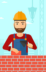 Image showing Bricklayer with spatula and brick.