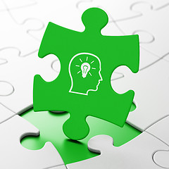 Image showing Advertising concept: Head With Lightbulb on puzzle background