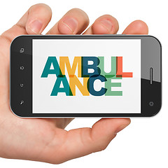 Image showing Healthcare concept: Hand Holding Smartphone with Ambulance on  display