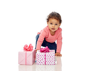 Image showing baby girl with birthday presents and confetti