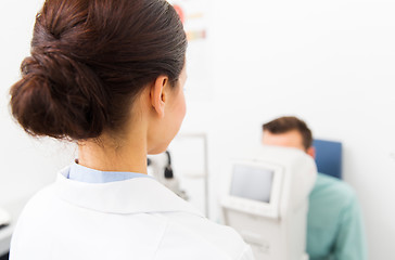 Image showing close up of optician and patient at eye clinic