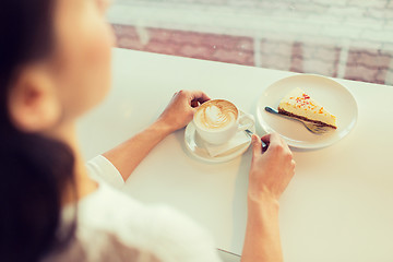 Image showing close up of woman hands with cake and coffee