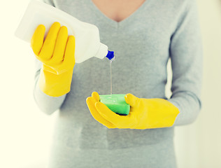 Image showing close up of woman with sponge and cleanser