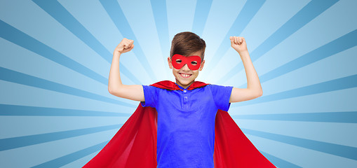 Image showing boy in red super hero cape and mask showing fists