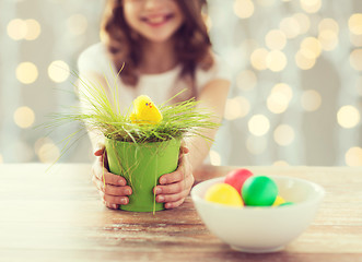 Image showing close up of girl holding pot with easter grass