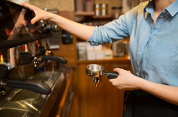 Image showing close up of woman making coffee by machine at cafe