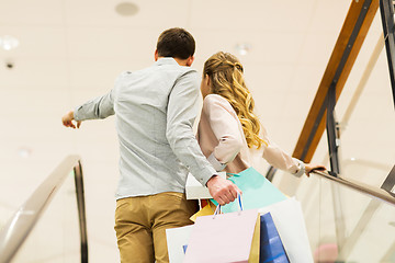 Image showing happy young couple with shopping bags in mall