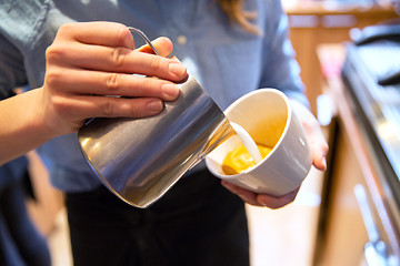 Image showing close up of woman making coffee at shop or cafe