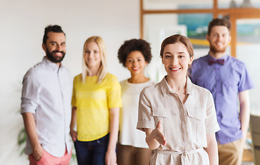 Image showing woman making handshake over creative office team