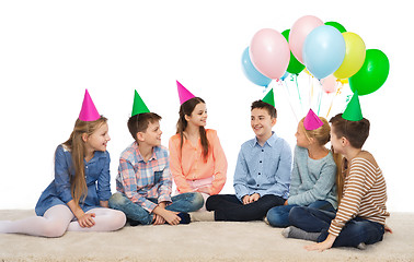 Image showing happy smiling children in party hats on birthday