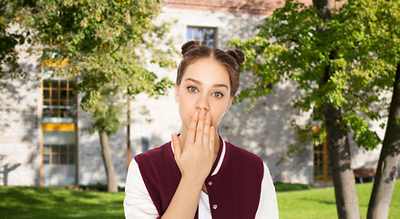 Image showing confused student girl covering her mouth by hand