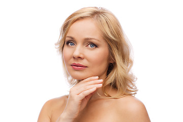 Image showing smiling woman with bare shoulders touching face