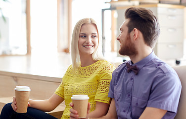 Image showing happy man and woman drinking coffee in office