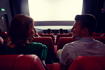 Image showing happy friends watching movie in theater